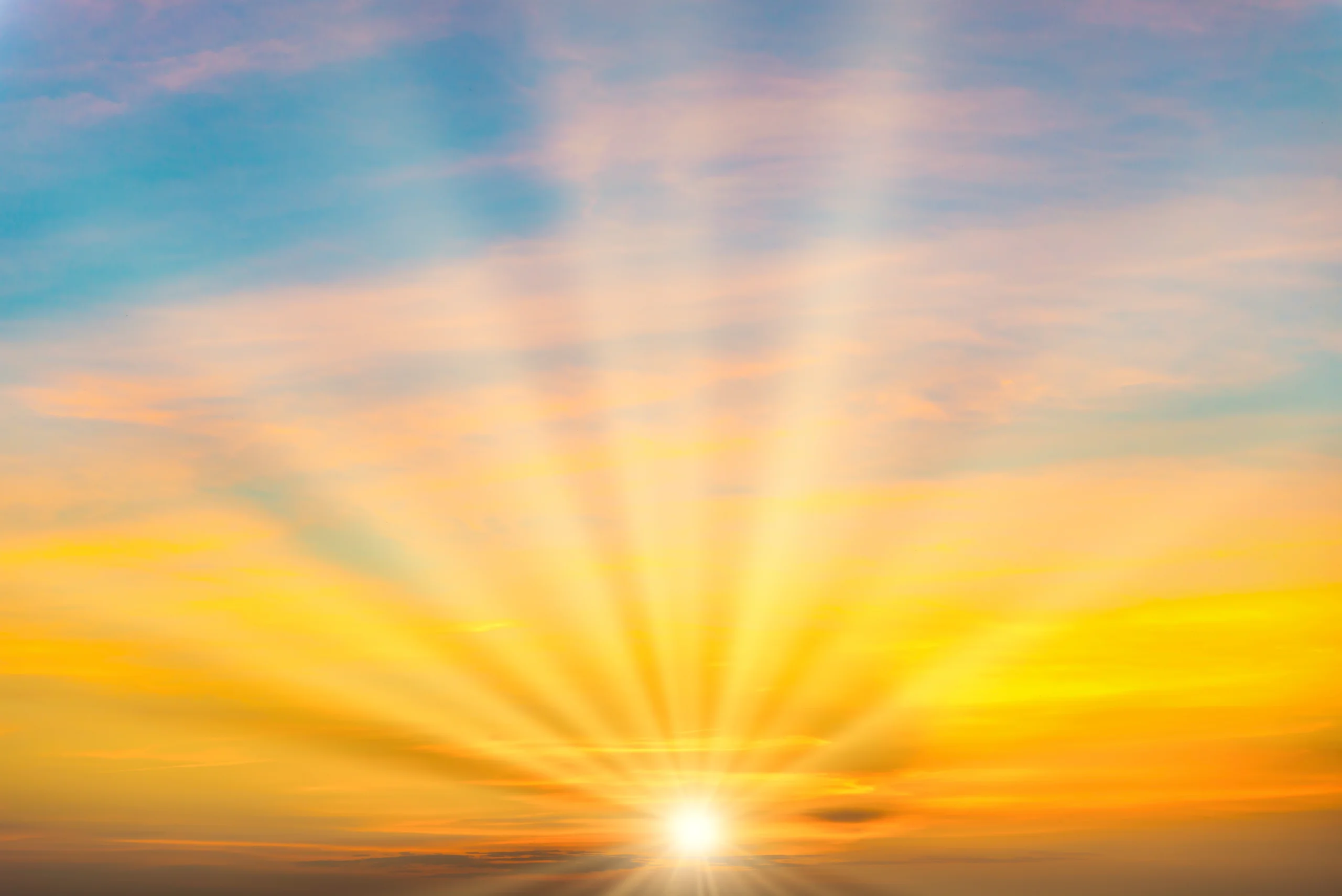 Sunrise breaking through clouds at dawn